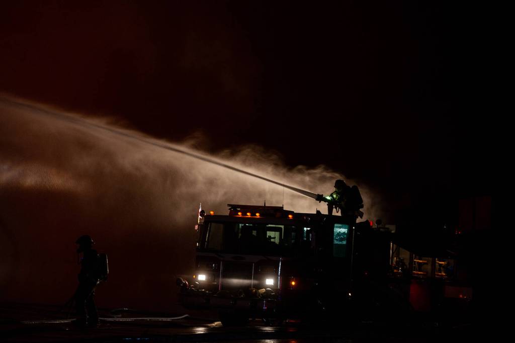 A Haines volunteer firefighter works on a massive blaze on Saturday, Oct. 5, 2024 in Haines. (Rashah Mcchesney/Chilkat Valley News)