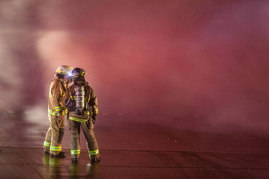 Haines fire chief Brian Clay talks to another firefighter on Saturday, Oct. 5, 2024, in Haines. (Rashah Mcchesney/Chilkat Valley News)