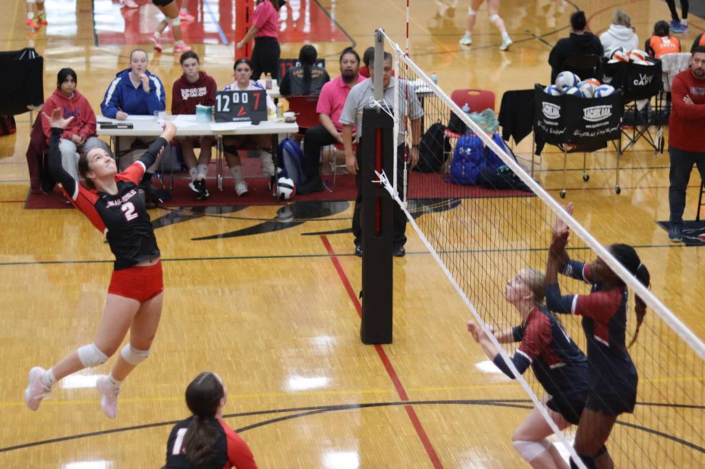 Braith Dihle (2) goes up for an attack for Juneau-Douglas High School: Yadaa.at Kale against Mountain City Christian Academy in an elimination game of the Juneau Invitational Volleyball Extravaganza on Saturday at JDHS. (Mark Sabbatini / Juneau Empire)