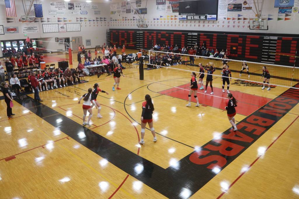 Teams from four schools, including Juneau-Douglas High School: Yadaa.at Kale, play on two courts Saturday during the Juneau Invitational Volleyball Extravaganza at JDHS. A total of 13 varsity teams participated in the tournament. (Mark Sabbatini / Juneau Empire)