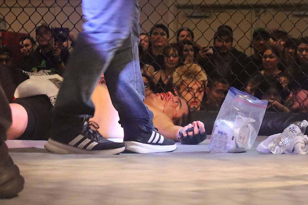 Colin Rose gets medical assistance after being slammed to the floor during his MMA fight against Damian Trujillo at AK Beatdown 36 on Saturday night at Elizabeth Peratrovich Hall. (Mark Sabbatini / Juneau Empire)