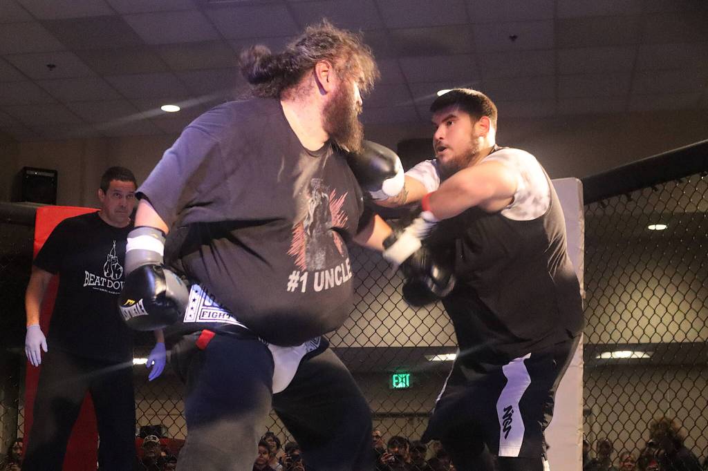 James Roberts (left), at 342 pounds, takes on 277-pound Eric Ashenfelter in the heavyweight match of the night during AK Beatdown 36 on Saturday night at Elizabeth Peratrovich Hall. (Mark Sabbatini / Juneau Empire)