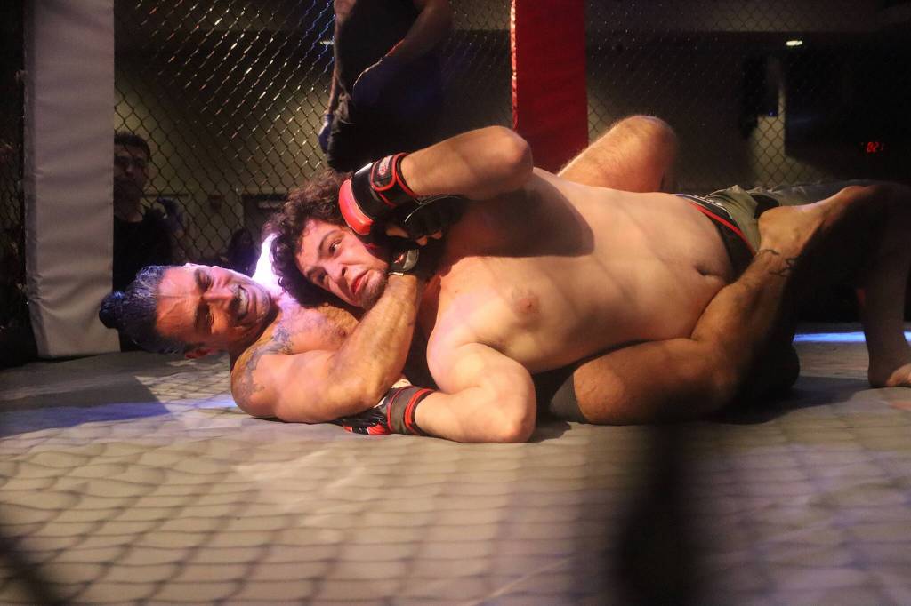 Scott Haas puts Duncan Meyer in a headlock during their MMA bout to open AK Beatdown 36 on Saturday night at Elizabeth Peratrovich Hall. (Mark Sabbatini / Juneau Empire)