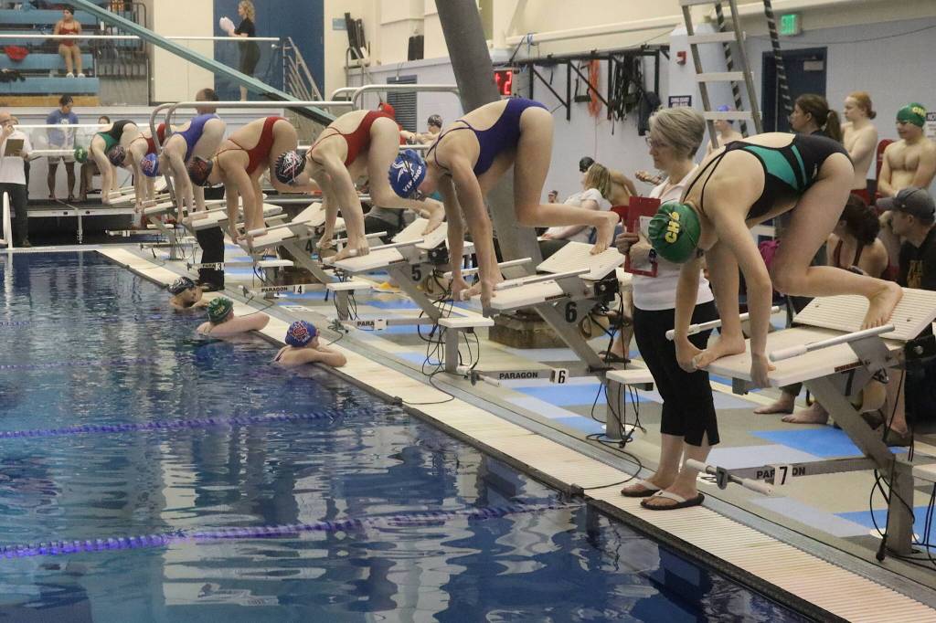 Girls await the start of a 100-meter fly race during a regional meet Saturday at Dimond Park Aquatic Center. (Mark Sabbatini / Juneau Empire)