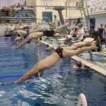Boys dive in for a 100-meter freestyle race during a regional meet Saturday at Dimond Park Aquatic Center. (Mark Sabbatini / Juneau Empire)