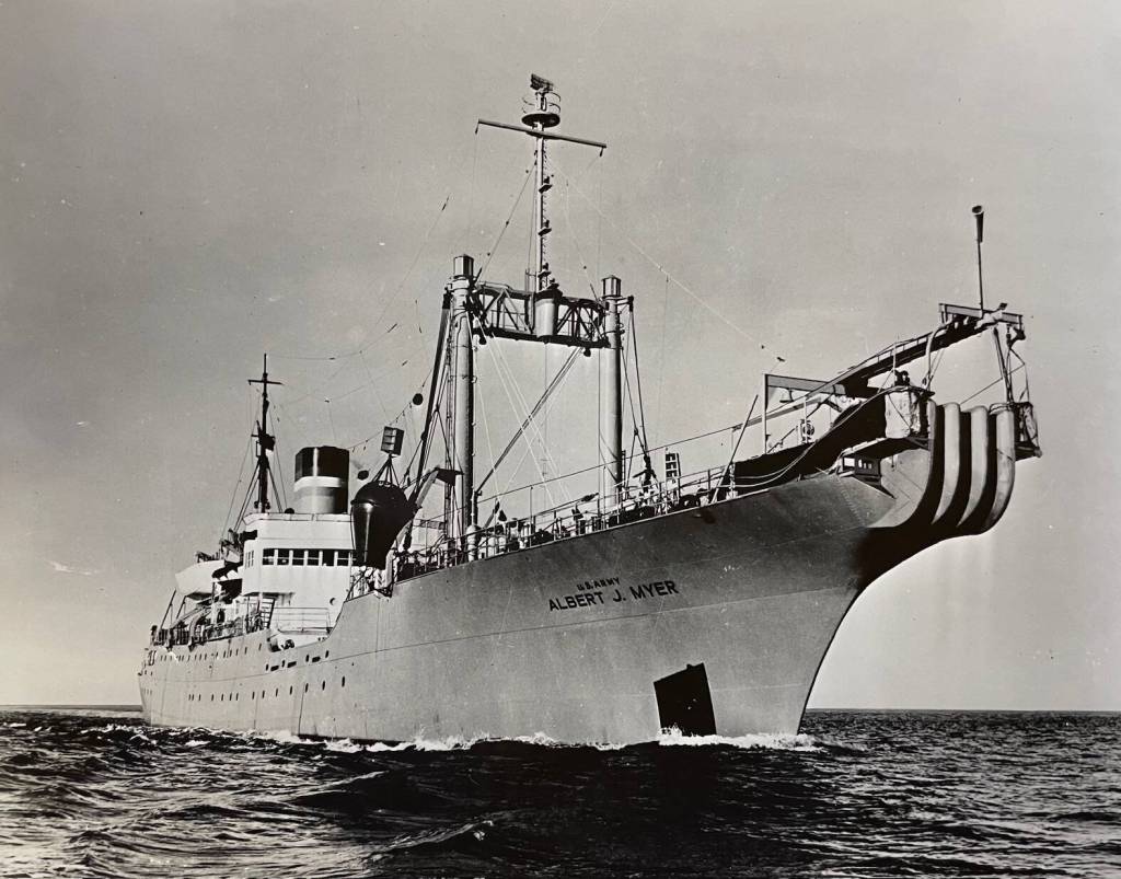 The U.S. Army cableship Albert J. Myer in 1956 with its specialized bow track for spooling out telecommunications cables. The ship was named after an assistant Army surgeon who in 1860 developed a system of flag signaling to communicate messages. It became the militarys Signal Corps, as stated in the Congressional Record testimony of Alaska Delegate Bob Bartlett in 1948. (PCA-64-1895)