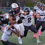Juneau Huskies senior Jayden Johnson (4), senior Hayden Aube (2) and junior Ricky Tupou (77) try to bring down West Anchorage senior Zephaniah Sailele (6) during the Huskies 20-13 loss to the Eagles in the 2024 ASAA State Football Playoffs on Saturday at West Anchorages Nest on Hillcrest. (Klas Stolpe/Juneau Empire)