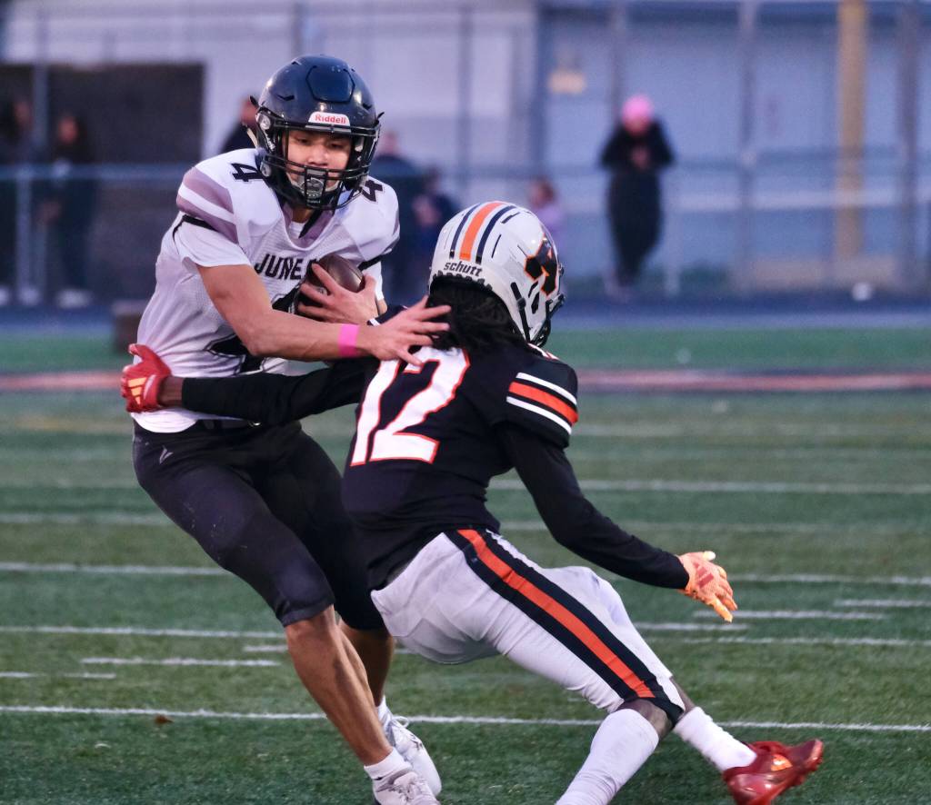 Juneau Huskies senior Jayden Johnson (4) pushes past West Anchorage junior defensive back Talon Copeland (12) during the Huskies 20-13 loss to the Eagles in the 2024 ASAA State Football Playoffs on Saturday at West Anchorages Nest on Hillcrest. (Klas Stolpe/Juneau Empire)