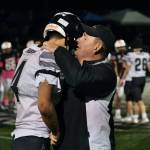Juneau coach Rich Sjoroos consoles senior Jayden Johnson (4) after the Huskies 20-13 loss to the Eagles in the 2024 ASAA State Football Playoffs on Saturday at West Anchorages Nest on Hillcrest. (Klas Stolpe/Juneau Empire)