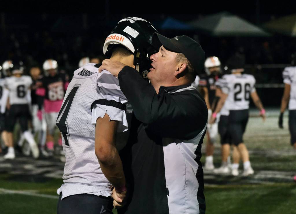 Juneau coach Rich Sjoroos consoles senior Jayden Johnson (4) after the Huskies 20-13 loss to the Eagles in the 2024 ASAA State Football Playoffs on Saturday at West Anchorages Nest on Hillcrest. (Klas Stolpe/Juneau Empire)