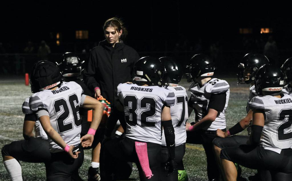 Juneau manager Zoe Mahle tends to the Huskies during a break in the action against West Anchorage in the 2024 ASAA State Football Playoffs on Saturday at West Anchorages Nest on Hillcrest. (Klas Stolpe/Juneau Empire)