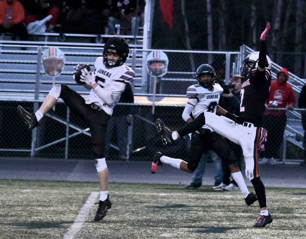 Juneau senior Sage Schultz (5) intercepts a pass to West Anchorage senior Ariel Sanchez (2) as Juneau junior Daniel Campbell (8) covers the outside during the Huskies 20-13 loss to the Eagles in the 2024 ASAA State Football Playoffs on Saturday at West Anchorages Nest on Hillcrest. (Klas Stolpe/Juneau Empire)