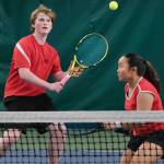 Juneau-Douglas High School: Yadaa.at Kalé senior Alex Rehfeldt and senior Milina Mazon play a ball during their mixed doubles match for the 2024 ASAA Tennis Championship on Saturday at Anchorages Alaska Club. (Klas Stolpe / Juneau Empire)