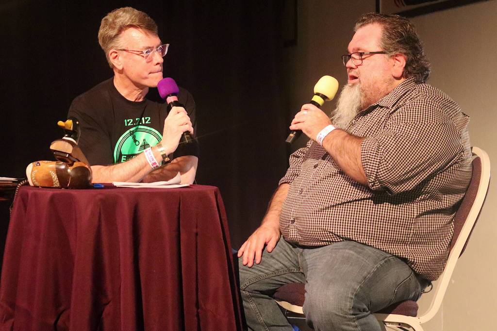 Andy Kline (left), a host of KTOOs Juneau Afternoon, interviews Abel Ryan, a board member of the Juneau Arts and Humanities Council, during KTOOs 50-Fest on Saturday night at the Juneau Arts and Culture Center. (Mark Sabbatini / Juneau Empire)
