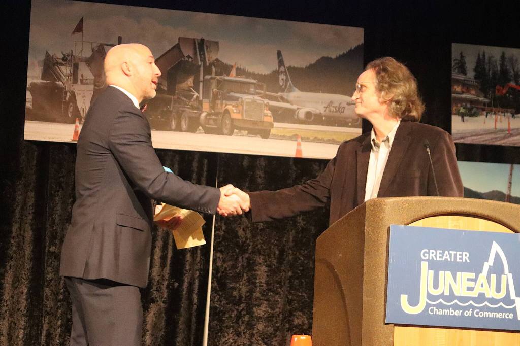 John Blasco (left) congratulates Bruce Simonson of the Juneau Bach Society as he is presented with the Greater Juneau Chamber of Commerces Lifetime Achievement award Saturday at Centennial Hall. (Mark Sabbatini / Juneau Empire)