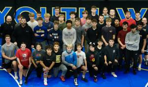 Members of the Juneau-Douglas High School: Yadaa.at Kalé Crimson Bears wrestling team are shown at the Juneau Wrestling Center during practice on Wednesday. (Klas Stolpe/Juneau Empire)