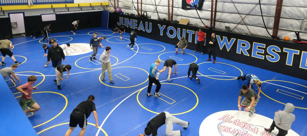 The Juneau-Douglas High School: Yadaa.at Kalé Crimson Bears wrestling team warm up during practice on Wednesday. (Klas Stolpe/Juneau Empire)