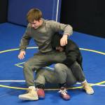 Juneau-Douglas High School: Yadaa.at Kalé Crimson Bears co-captain Justus Darbonne takes down co-captain Carvin Hass during practice on Wednesday. (Klas Stolpe/Juneau Empire)