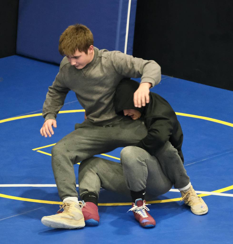 Juneau-Douglas High School: Yadaa.at Kalé Crimson Bears co-captain Justus Darbonne takes down co-captain Carvin Hass during practice on Wednesday. (Klas Stolpe/Juneau Empire)