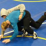 Sophomore Landon Dunn practices a takedown on senior Colton Cummins during the Juneau-Douglas High School: Yadaa.at Kalé Crimson Bears wrestling team practice on Wednesday. (Klas Stolpe/Juneau Empire)