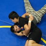 Senior Hayden Aube works a pin on junior Jaxin Jim. during the Juneau-Douglas High School: Yadaa.at Kalé Crimson Bears wrestling team practice on Wednesday. (Klas Stolpe/Juneau Empire)
