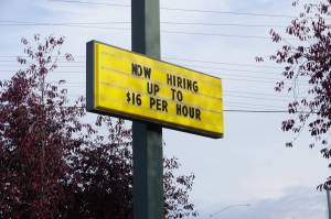 A sign outside of a McDonalds restaurant in Midtown Anchorage, seen on Oct. 7, advertises openings for jobs that pay up to $16 an hour. Voters will decide the fate of a ballot measure that would set a $15-an-hour minimum wage by 2027 and mandate paid sick leave for workers. (Yereth Rosen/Alaska Beacon)
