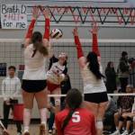 Juneau-Douglas High School: Yadaa.at Kalé sophomore June Troxel (1) kills a shot between Wasilla seniors Layla Hays and Hayden Caldera during the Crimson Bears loss to the Warriors on Friday night at the George Houston Gymnasium. (Klas Stolpe/Juneau Empire)