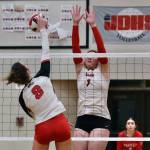JDHS senior Evelyn Richards (8) kills a shot past Wasilla senior Layla Hays (1) during the Crimson Bears loss to the Warriors on Friday night at the George Houston Gymnasium. (Klas Stolpe/Juneau Empire)