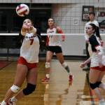 JDHS sophomore Leila Cooper (7) bumps a ball as senior Tatum Billings moves into position against Wasilla on Friday. (Klas Stolpe/Juneau Empire