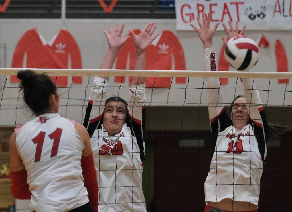 Juneau-Douglas High School: Yadaa.at Kalé junior Natalia Harris (20) and sophomore Amelia Effers (13) attempt to block a shot by Wasilla junior Ki Schachle (11) on Friday. (Klas Stolpe/Juneau Empire)