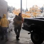 Weston Holland loads sandbags into his truck outside the Mendenhall Valley Public Library on Saturday morning. His home on Emily Way was among the hardest hit by record flooding from Suicide Basin on Aug 6. (Mark Sabbatini / Juneau Empire)