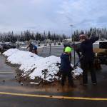 Molly Zaleski and her son, Aedan, 8, load sandbags from a sandpile in the parking lot of Thunder Mountain Middle School on Saturday morning. (Mark Sabbatini / Juneau Empire)