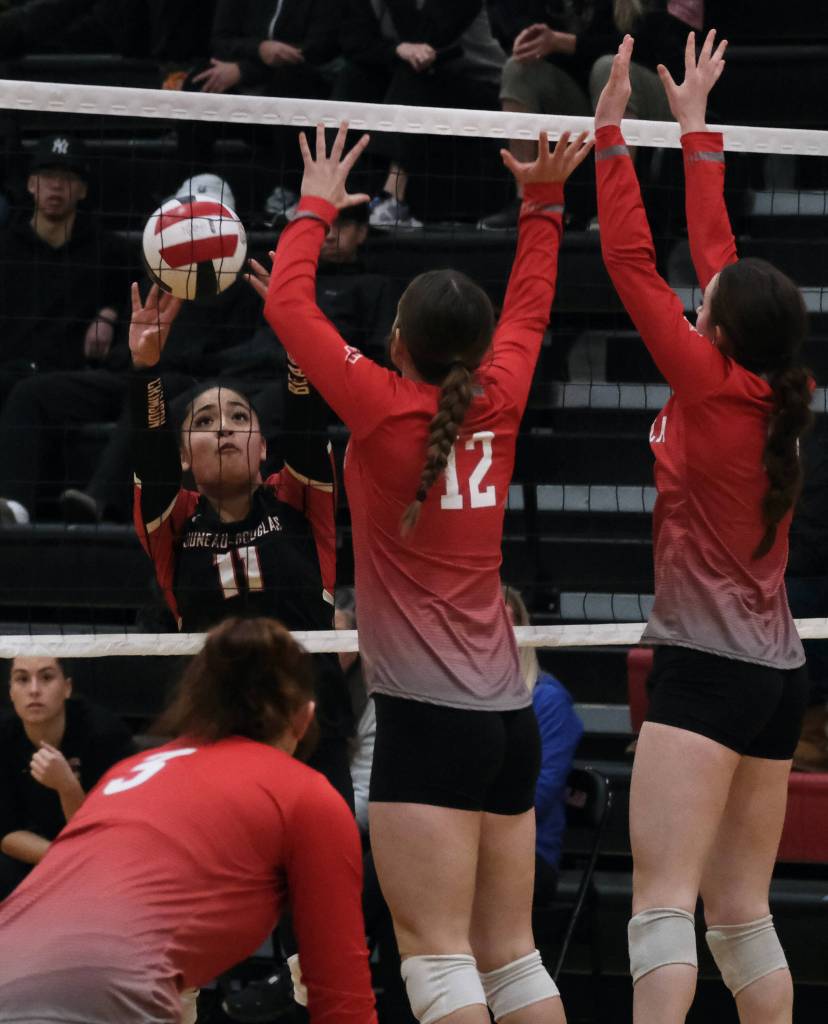 Juneau-Douglas High School: Yadaa.at Kalé junior Lavinia Maake (11) hits a set-over shot against Wasilla during the Crimson Bears three-set loss to the visiting Warriors on Saturday at the George Houston Gymnasium. (Klas Stolpe/Juneau Empire)