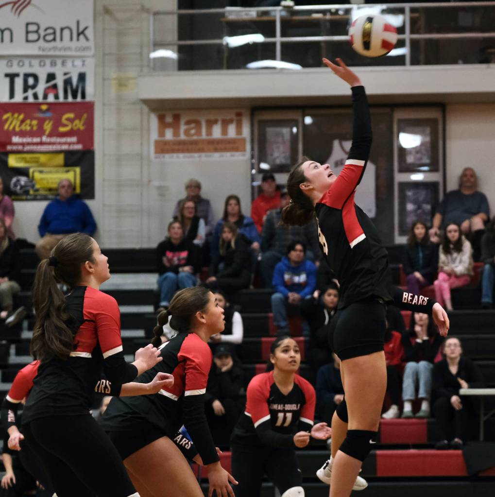 Juneau-Douglas High School: Yadaa.at Kalé senior Evelyn Richards hits a shot as sophomores June Troxel and Leila Cooper and junior Lavinia Maake (11) back up the play against Wasilla during the Crimson Bears three-set loss to the visiting Warriors on Saturday at the George Houston Gymnasium. (Klas Stolpe/Juneau Empire)