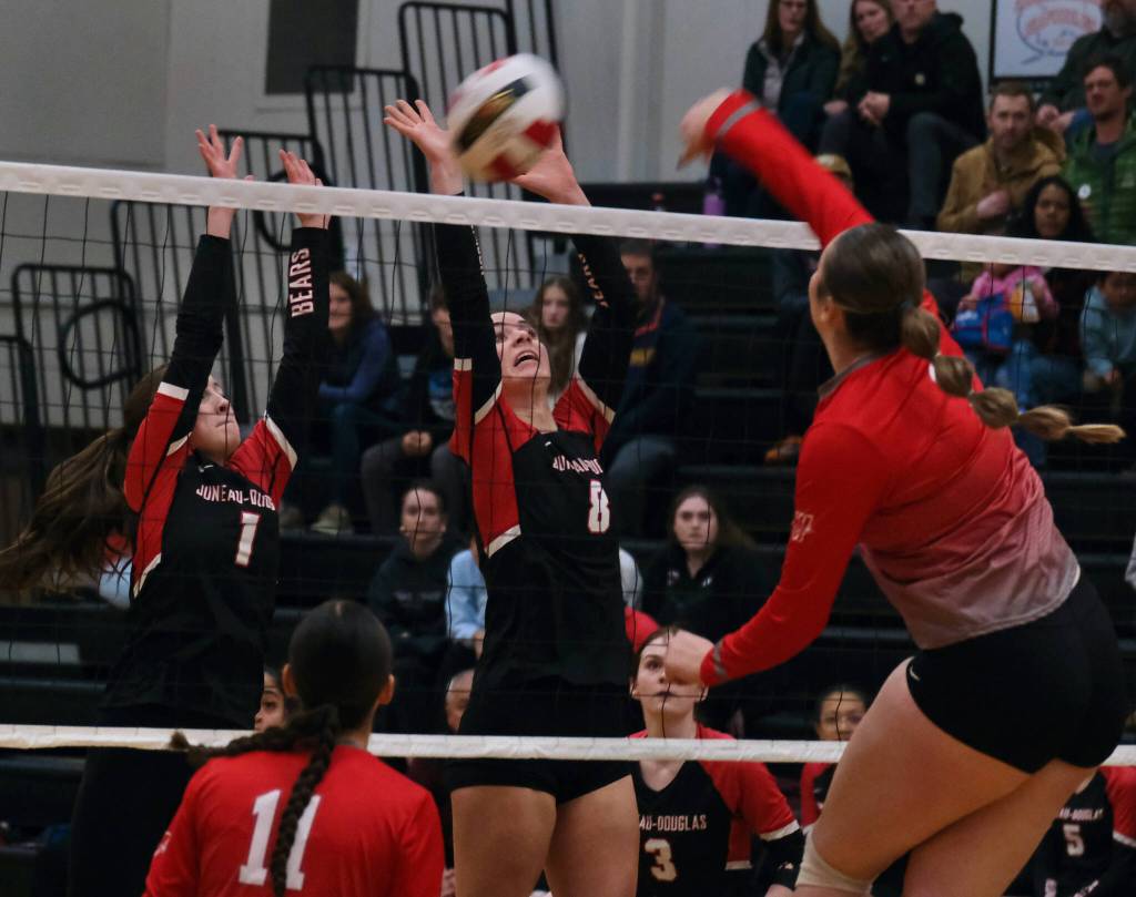 Juneau-Douglas High School: Yadaa.at Kalé sophomore June Troxel (1) and senior Evelyn Richards (8) block a kill by Wasilla senior Layla Hays during the Crimson Bears three-set loss to the visiting Warriors on Saturday at the George Houston Gymnasium. (Klas Stolpe/Juneau Empire)