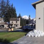 Sandbags are stacked outside a home Sunday afternoon on Meander Way , where flood waters are expected to seep when a glacial outburst flood from Suicide Basin peaks early Monday morning. (Mark Sabbatini / Juneau Empire)