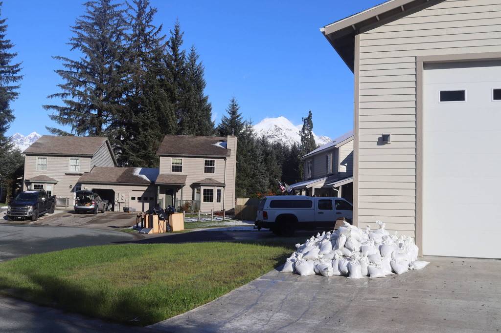 Sandbags are stacked outside a home Sunday afternoon on Meander Way , where flood waters are expected to seep when a glacial outburst flood from Suicide Basin peaks early Monday morning. (Mark Sabbatini / Juneau Empire)