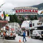 Electricians replace sections of neon tubing on a sign that greets visitors to Ketchikan, a fishing community turned cruise ship stop with a population of 8,000, Oct. 9, 2024. Deadly landslides are increasing around the world, but in parts of Alaska, maps of the hazards remain controversial. (Christopher Miller/The New York Times)