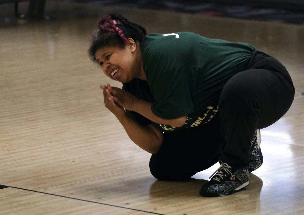 Evvanne Menefee adds a little prayer to her ball delivery during the Juneau Special Olympics bowling games Sunday at Pinz Bowling Alley. (Klas Stolpe/Juneau Empire)