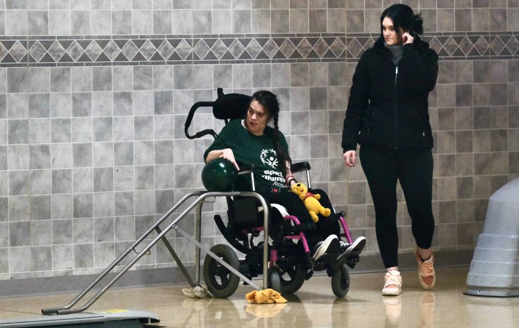 Sabrina Richmond and Danielle Zimmerer watch Richmonds ball delivery during the Juneau Special Olympics bowling games Sunday at Pinz Bowling Alley. (Klas Stolpe/Juneau Empire)