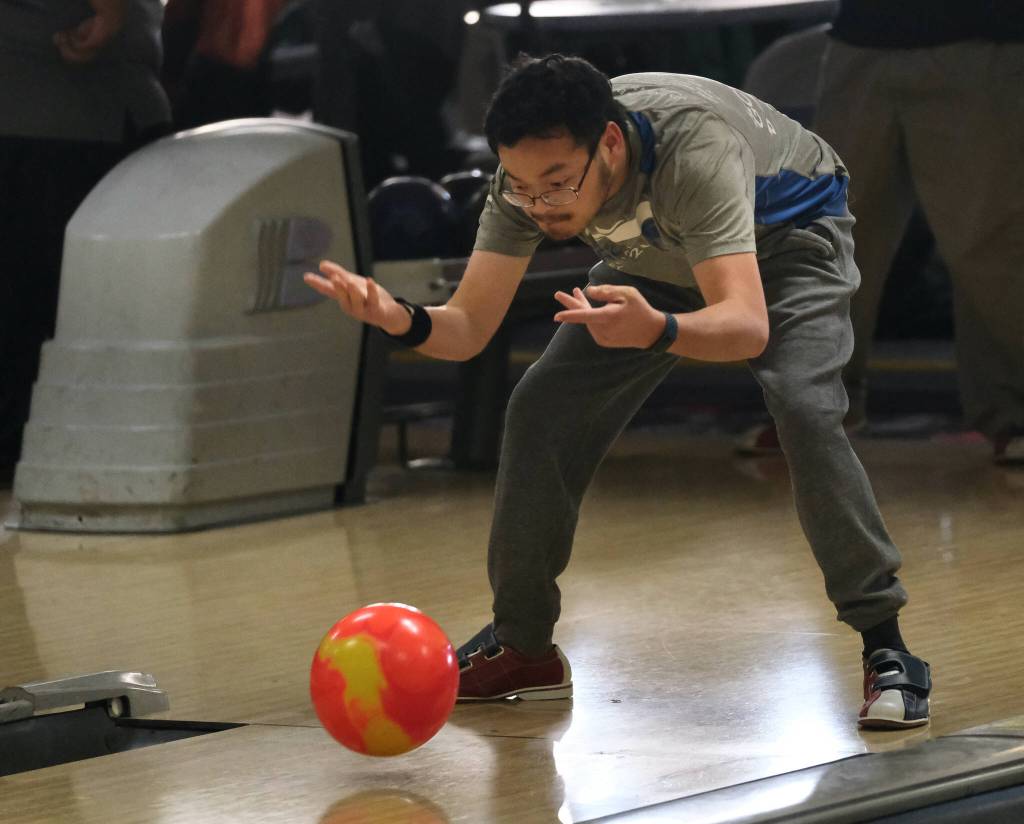 Fu Bao Hartle delivers a ball during the Juneau Special Olympics bowling games Sunday at Pinz Bowling Alley. (Klas Stolpe/Juneau Empire)