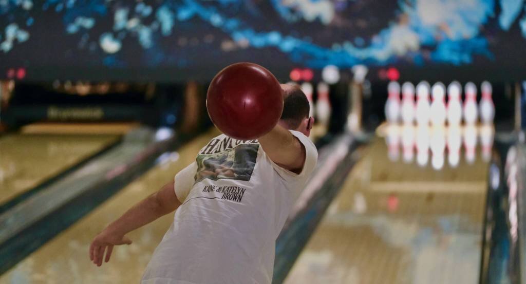 Ryan Story delivers a ball during the Juneau Special Olympics bowling games Sunday at Pinz Bowling Alley. (Klas Stolpe/Juneau Empire)
