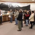 Juneau Mayor Beth Weldon and Assembly member Greg Smith (left) read a formal apology to members of the Douglas Indian Association during an Assembly meeting Monday night, acknowledging the City and Borough of Juneaus role in the burning of the Douglas Indian Village in 1962. (Mark Sabbatini / Juneau Empire)