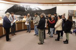 Juneau Mayor Beth Weldon and Assembly member Greg Smith (left) read a formal apology to members of the Douglas Indian Association during an Assembly meeting Monday night, acknowledging the City and Borough of Juneaus role in the burning of the Douglas Indian Village in 1962. (Mark Sabbatini / Juneau Empire)