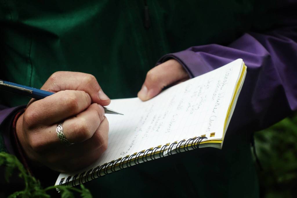 Annette Patton, lead geoscientist for Sitka Sound Science Center, takes field notes at a WeatherChime installation in Hoonah. (Photo by Zofia Danielson)