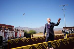 President Joe Biden waves after delivering remarks on the federal governments role in running boarding schools for Native American children at the Gila Crossing Community School in Gila River Indian Community near Phoenix, Ariz., Oct. 25, 2024. Biden on Friday formally apologized for the role of the federal government in running boarding schools where thousands of Native American children faced abuse, neglect and the erasure of their tribal identities. (Eric Lee/The New York Times)