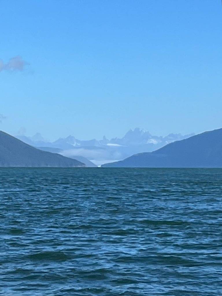 A photo showing 8,584-foot Devils Paw from the Taku River inlet south of Juneau. The solitary rock spike called Michaels Sword is visible to the left. Devils Paw is designated as Boundary Peak 93 on the map of approximately 185 border peaks from Hyder, Alaska, and Stewart, British Columbia, north to Mount Saint Elias at the 141st meridian. (Photo courtesy of Cathy Connor)