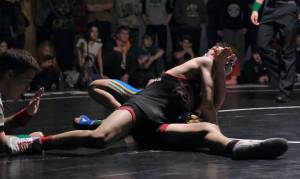 Juneau-Douglas High School: Yadaa.at Kalé sophomore Camden Messmer pins Skagway junior Brenden Moncibaiz in their 119-pound title match on Saturday at the Southeast Showdown Wrestling Tournament in Juneaus George Houston Gymnasium. (Klas Stolpe / Juneau Empire)