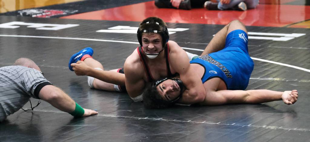 Juneau-Douglas High School: Yadaa.at Kalé sophomore Jaxin Jim attempts to pin Petersburg senior Kaden Duke during their 171-pound semifinal match on Saturday at the Southeast Showdown Wrestling Tournament in Juneau's George Houston Gymnasium. Darbonne won by Fall. Duke would win in extra time. (Klas Stolpe / Juneau Empire)