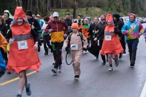 Participants race in the Halloween Half Marathon and 5K on Saturday along North Douglas Highway. (Klas Stolpe / Juneau Empire)